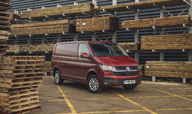 Volkswagen Transporter 6.1 between high rise racking with wooden panels and pallets surrounding 
