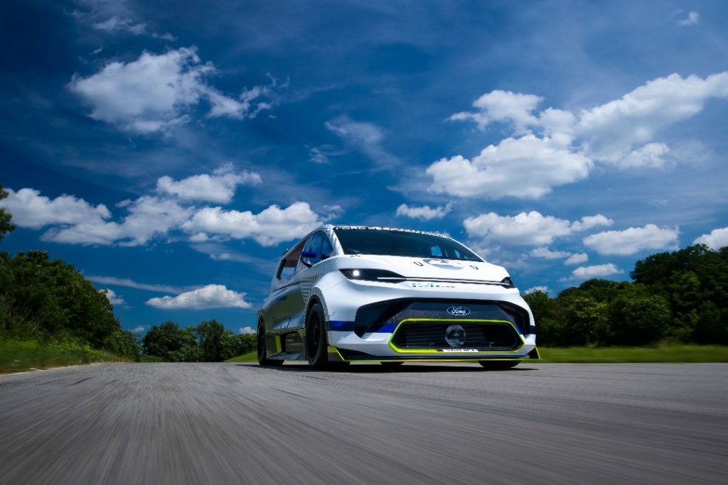 dramatic photo of Ford Electric SuperVan against cloud background
