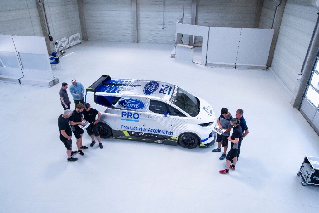 Electric SuperVan in the workshop surrounded by Ford staff