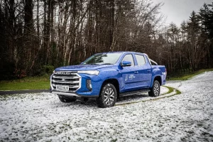 Maxus T90EV pick-up truck in blue on snow covered grass