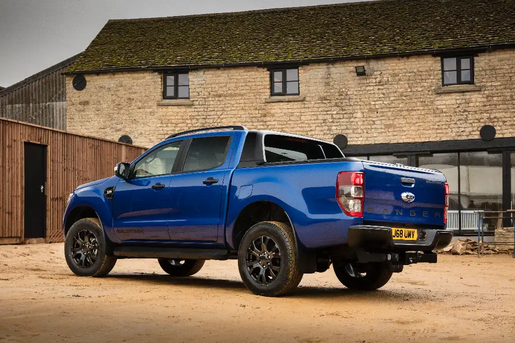Ford Ranger Wildtrak X rear view parked in front of a converted farmyard buliding 