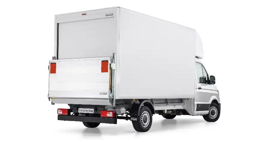 Rear view of a Luton van in white with a roller shutter door and a tail lift built on a Volkswagen Crafter chassis