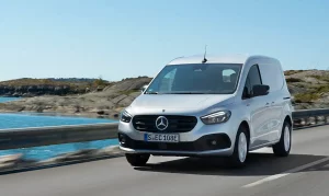 Mercedes-Benz eCitan on a road crossing a bridge with a blue sky and water behind