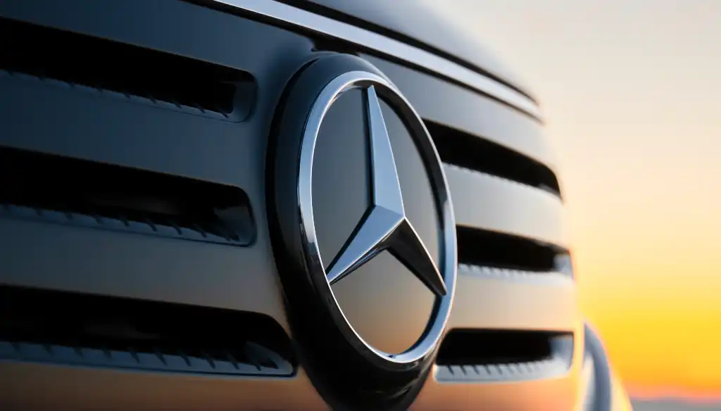 Mercedes logo with a sunset behind