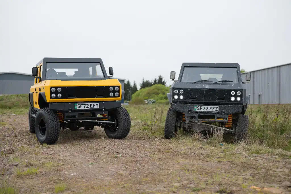 Two Munro MK_1 pick-up trucks parked side by side