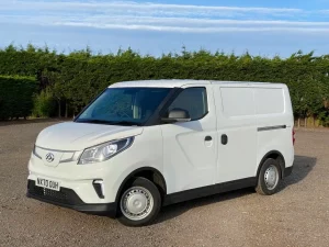 Maxus eDeliver 3 in white front three quarters on a gravel surface with green hedges behind