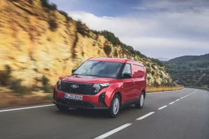 Ford Transit Courier in red, on a mountain road