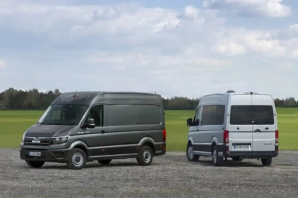 Two MAN TGEs parked next to each other showing the front and the rear of the van
