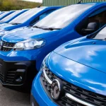 A line up of blue vans for an article on buying a new van