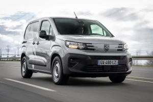 Peugeot E-Partner review picture on the road in silver grey with a Peugeot vans livery on the side