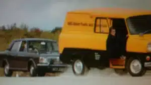 George Barrow falling out of a Transit van dressed as a bank robber