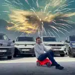 New vans with George Barrow on a toy bike and fireworks